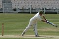 Mark Lomas strikes the ball through mid-wicket