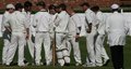 The Blackpool players gather at the fall of a wicket