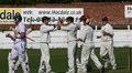 The Blackpool players congratulate Steven Croft as Adam Hornby returns to the pavillion out LBW